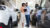 couple looking at clipboard in a car dealership