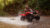 man driving four wheeler through mud